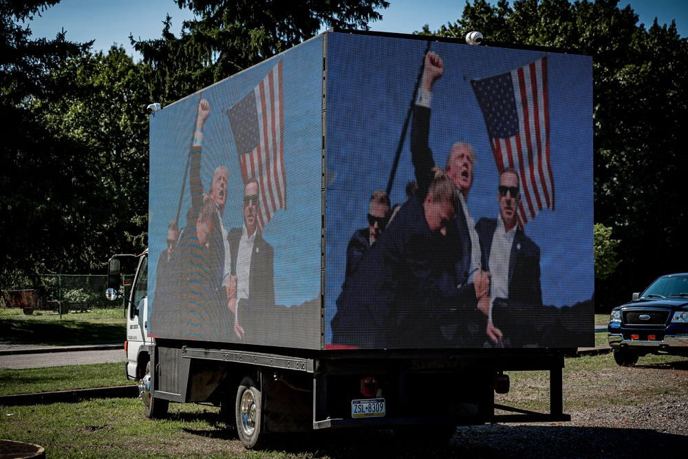 Truck with iconic Trump clenched fist at assassination scene. Red Caesar's Brush With Death