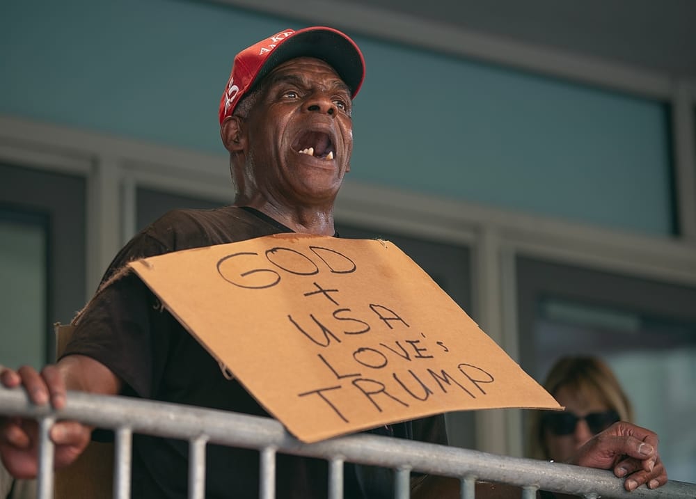A MAGA true believer proudly sports a made-up sign for his hero Trump. American Carnage Is Finally Here.