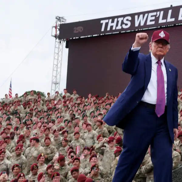 US President Donald Trump pumping his clenched fist, revolutionary style, in front of clueless US Army Airborne at Ft. Bragg, June 10, 2025.