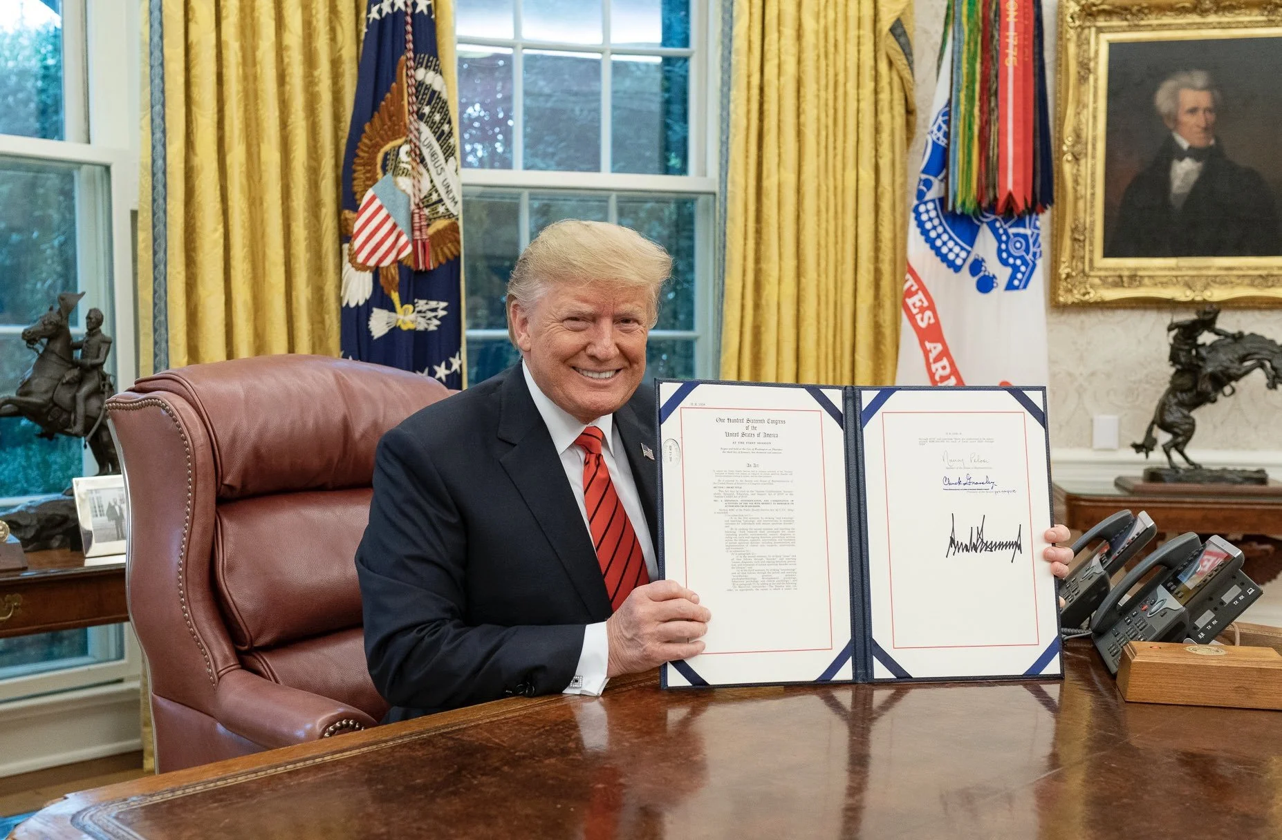 Donald Trump signs an Autism bill in the Oval Office, Oct. 12, 2019.